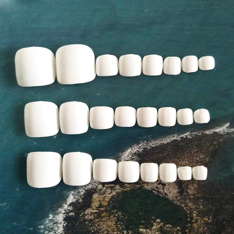 Glossy white toe nails